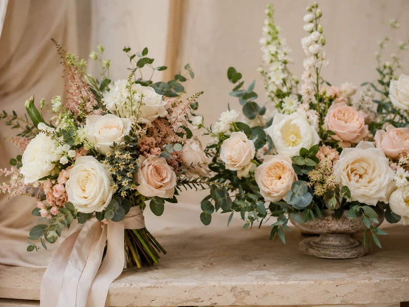 Red pink white and yellow roses arranged on a clean florist table