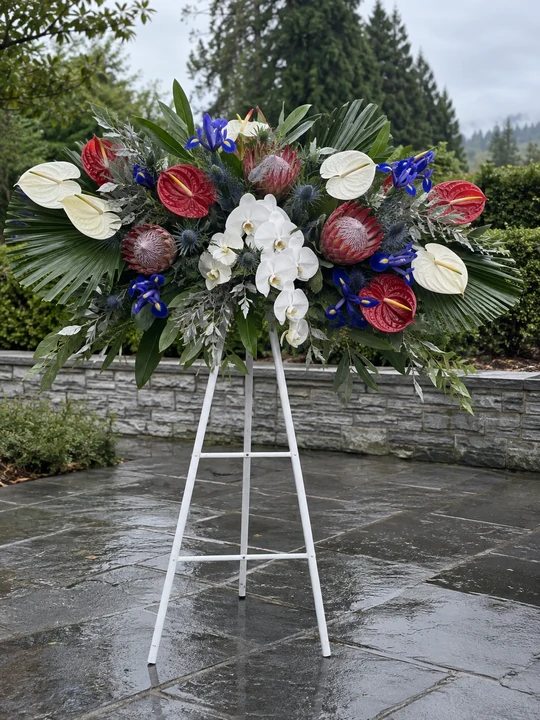 Red white and blue funeral standing spray at a Nashville service